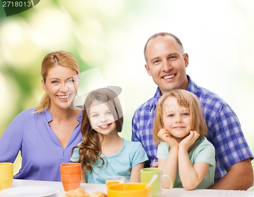 Image of happy family with two kids with having breakfast