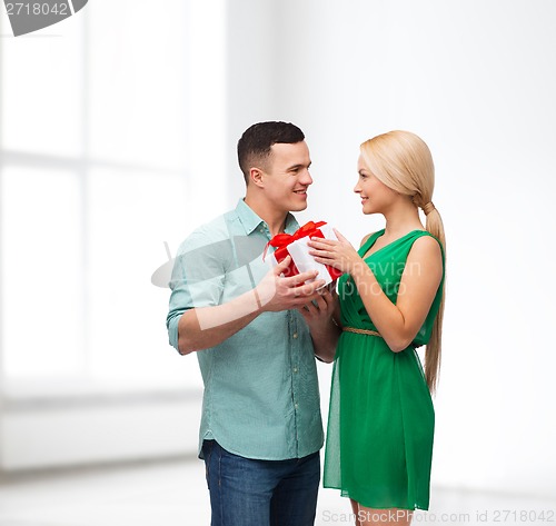 Image of smiling couple with gift box