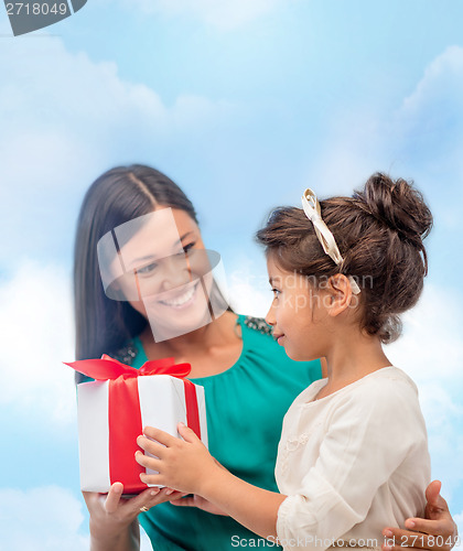 Image of happy mother and child girl with gift box