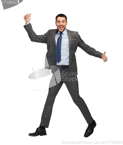 Image of smiling businessman jumping and showing thumbs up