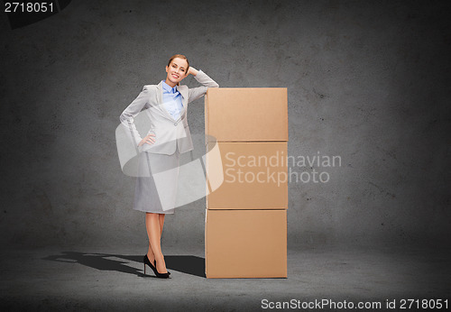 Image of smiling businesswoman with cardboard boxes