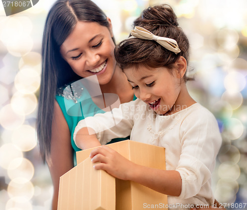 Image of happy mother and child girl with gift box