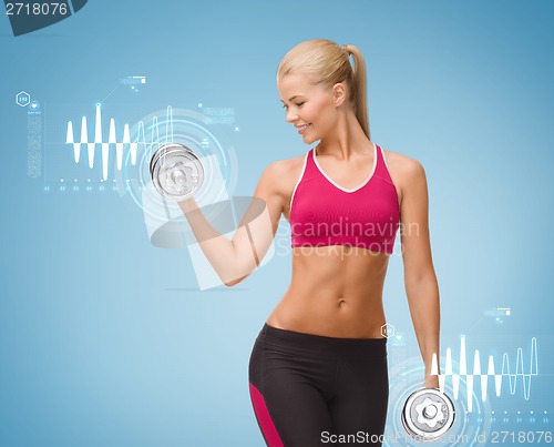 Image of smiling woman lifting steel dumbbell