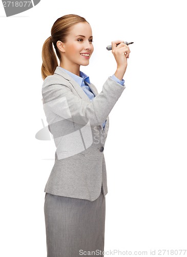 Image of businesswoman writing something in air with marker