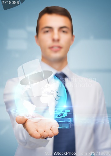 Image of friendly buisnessman showing globe on the palm