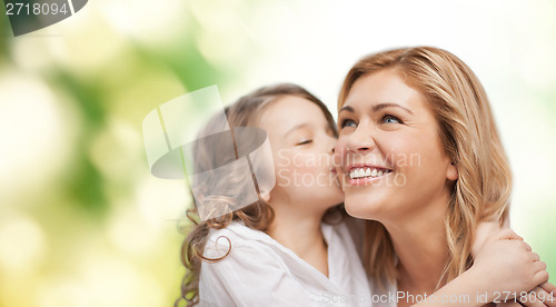 Image of smiling mother and daughter hugging