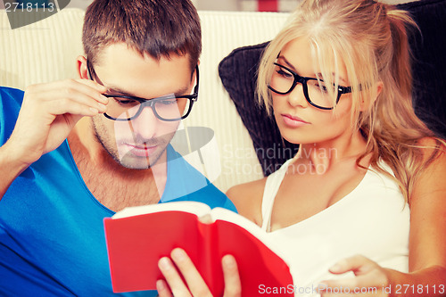 Image of couple at home with book