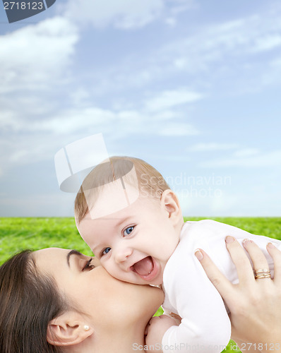 Image of laughing baby playing with mother