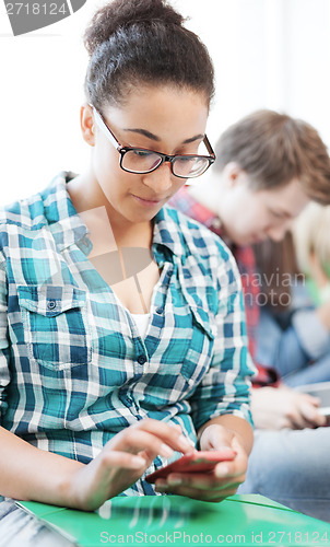Image of student girl with smartphone at school