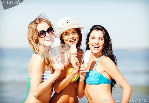 Image of girls in bikini with ice cream on the beach