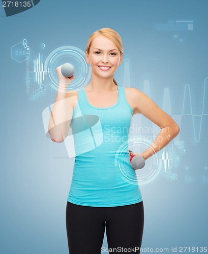 Image of young sporty woman with light dumbbells