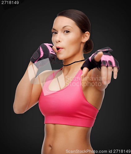 Image of asian personal trainer with whistle