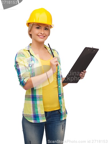 Image of smiling woman in helmet with clipboard