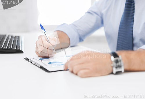 Image of businessman working and signing papers