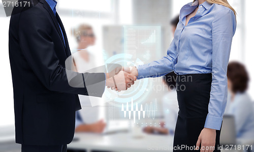 Image of man and woman shaking their hands in office