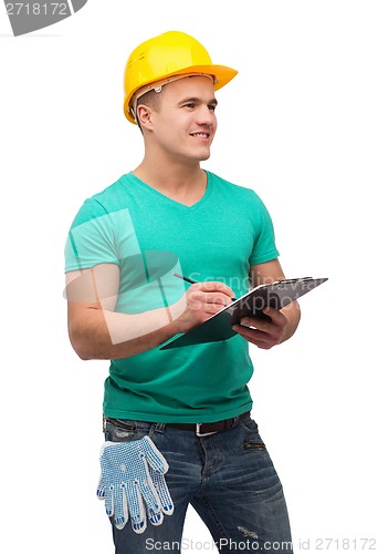 Image of smiling man in helmet with clipboard