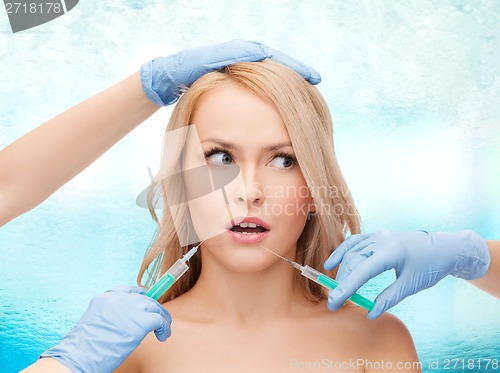 Image of woman face and beautician hands with syringes