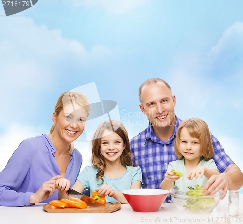 Image of happy family with two kids making dinner at home