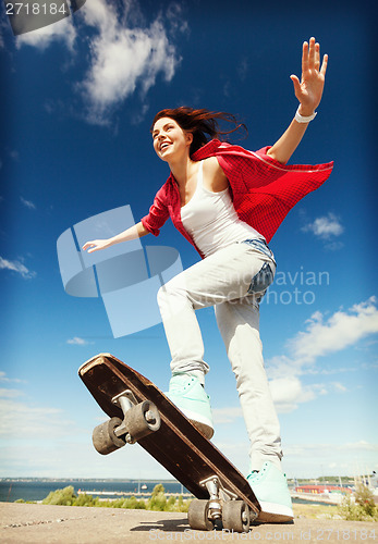 Image of teenage girl skating outside