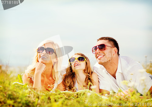 Image of happy family with blue sky and green grass
