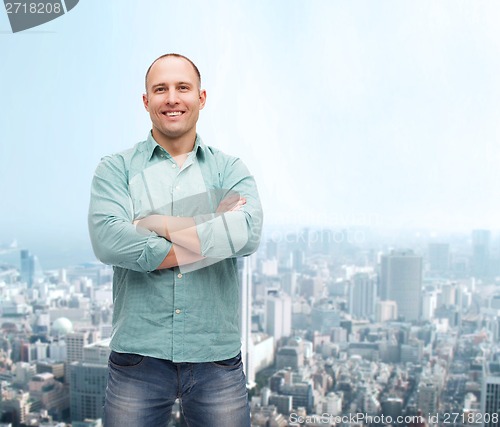 Image of smiling man with crossed arms