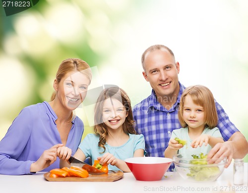 Image of happy family with two kids making dinner at home