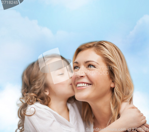 Image of smiling mother and daughter hugging