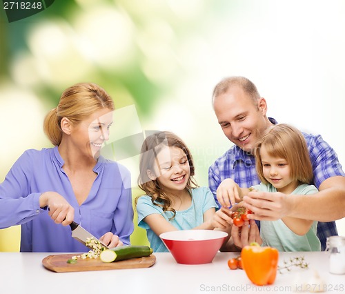 Image of happy family with two kids making dinner at home