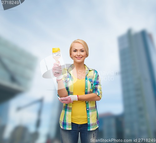 Image of smiling woman with paintbrush