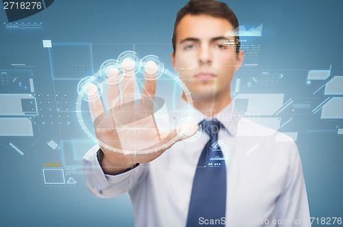 Image of attractive buisnessman working with virtual sceen