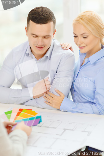 Image of couple looking at blueprint and color samples