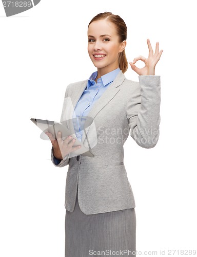 Image of smiling woman looking at tablet pc computer