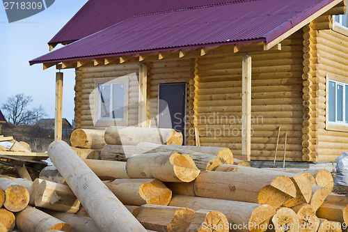 Image of Wooden house and a bunch of logs