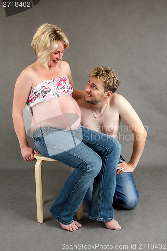 Image of loving happy couple, smiling pregnant woman with her husband