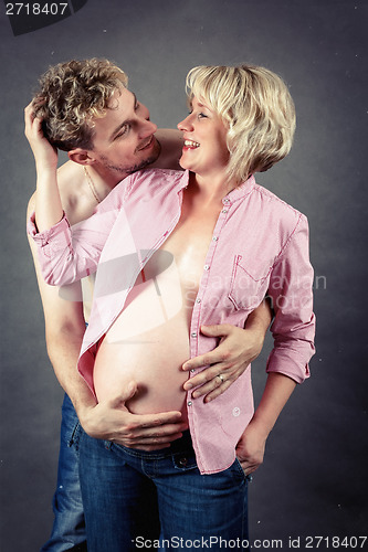 Image of loving happy couple, smiling pregnant woman with her husband