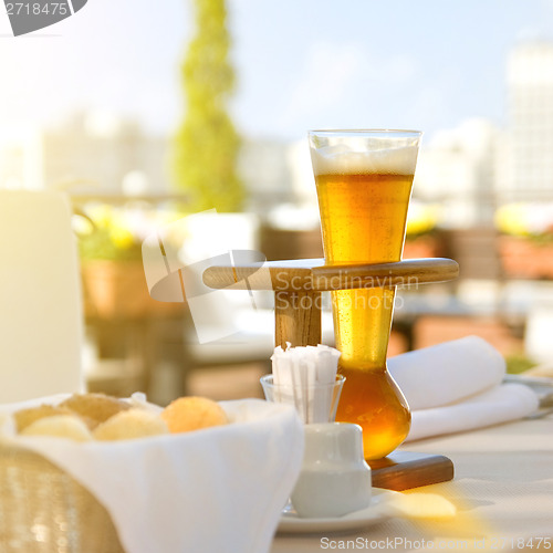 Image of Kwak beer on the served table. Outdoors photo.