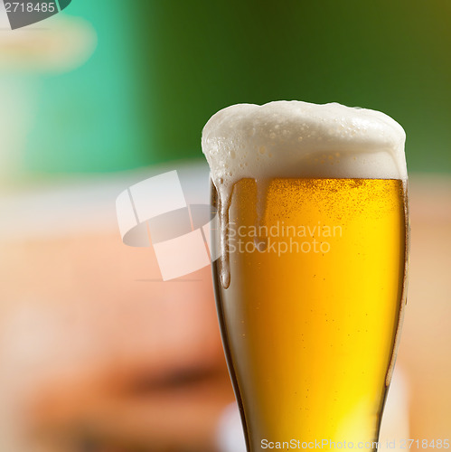 Image of Glass of light beer in pub