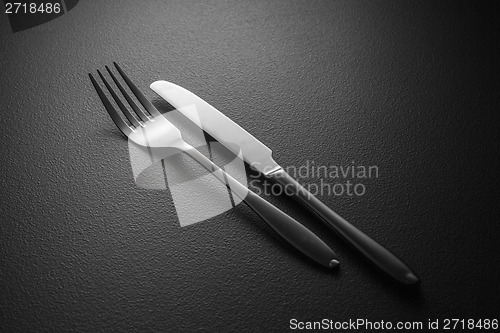 Image of knife and fork on black