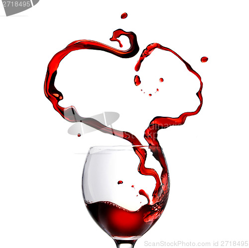 Image of Heart made of pouring red wine in glass isolated on white