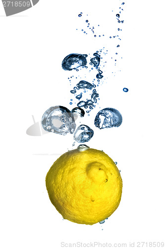 Image of Fresh lemon dropped into water with bubbles isolated on white