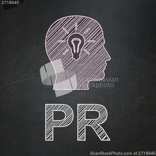 Image of Marketing concept: Head With Light Bulb and PR on chalkboard background