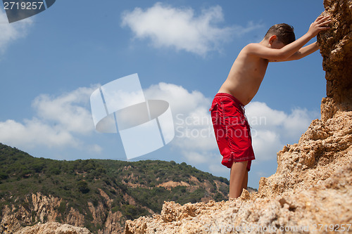 Image of Little boy climbing up