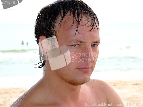 Image of Portrait of a wet young man day at the beach