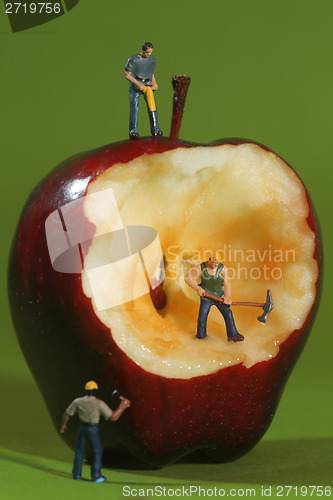 Image of Construction Workers in Conceptual Imagery With an Apple