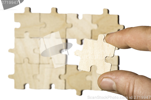 Image of Wooden puzzle on white background. . Close up