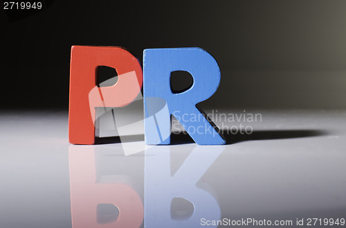 Image of Multicolored word PR made of wood.