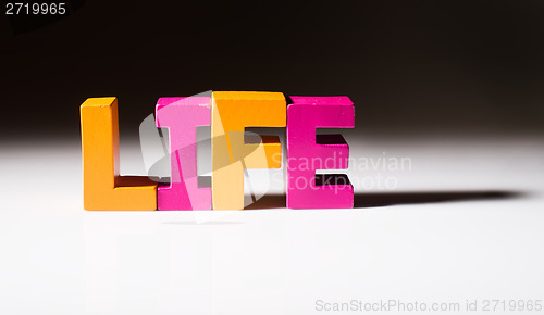 Image of Multicolored word life made of wood.