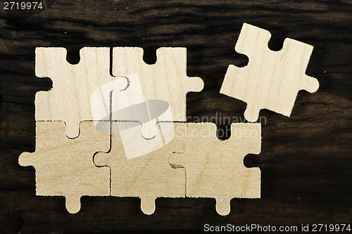 Image of Wooden puzzle on dark background. 