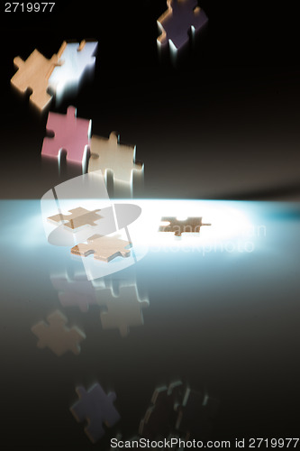 Image of Falling puzzle pieces.