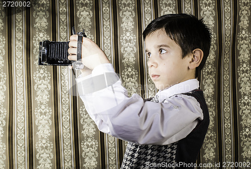 Image of Child taking pictures with vintage camera